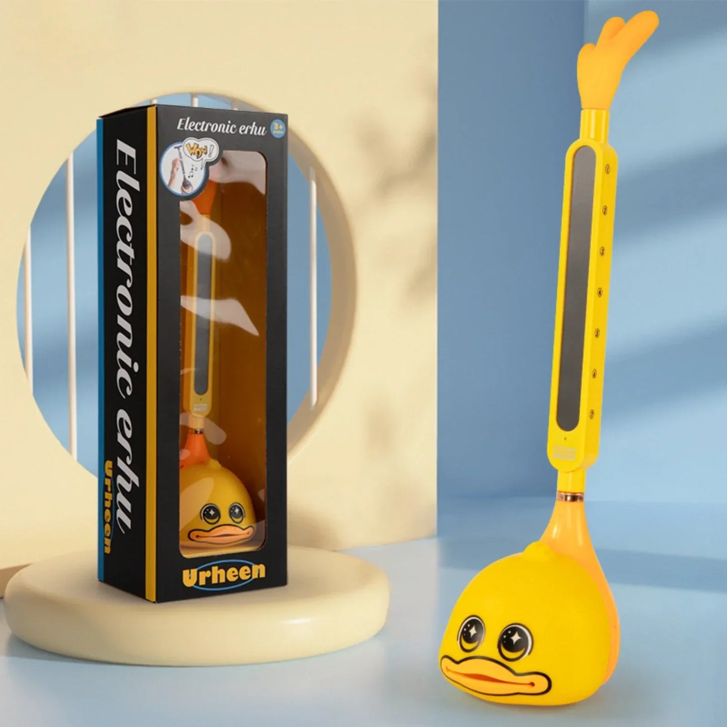 Yellow duck-shaped otamatone electronic musical toy with glossy plastic body and black eyes portable synthesizer for kids