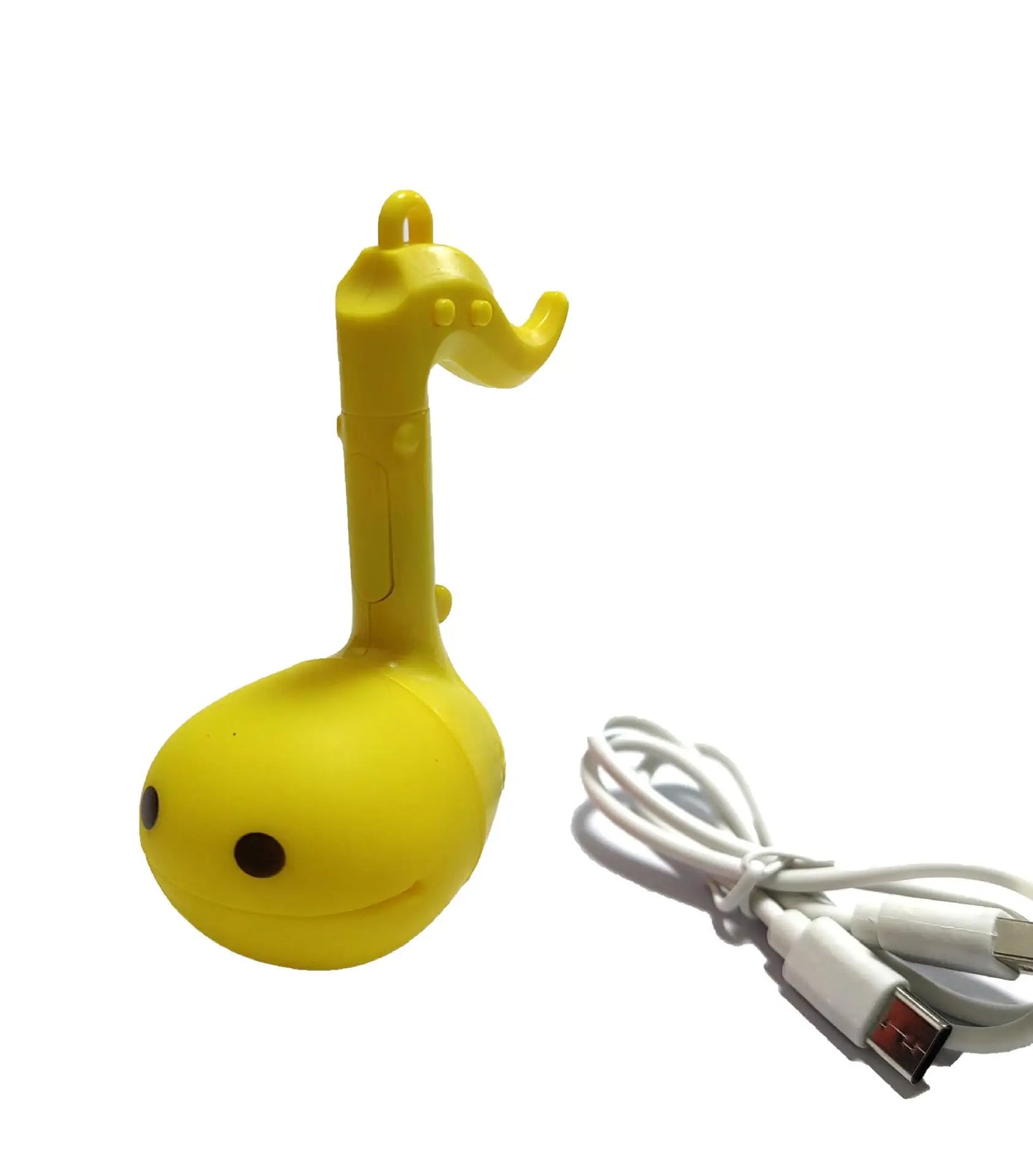 Yellow otamatone mini cute musical note-shaped electronic music toy with smiling face and elephant-like head design