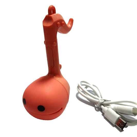 Orange plastic otamatone mini electronic usb flash drive shaped like koto with black eyes for musical toys soothing use