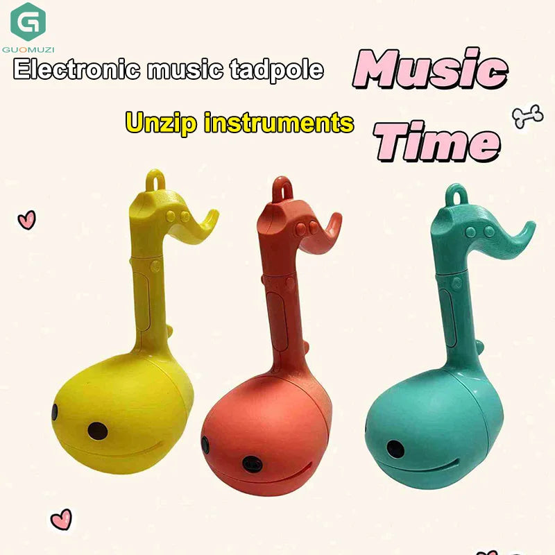 Three colorful yellow red and teal otamatone mini electronic musical toys soothing relaxing musical instruments with smiling faces