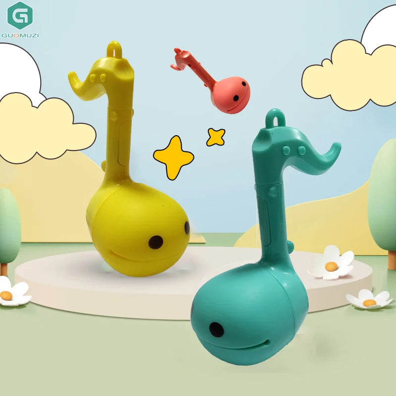 Yellow and teal otamatone mini electronic musical toys with smiling faces designed as soothing relaxing musical instruments