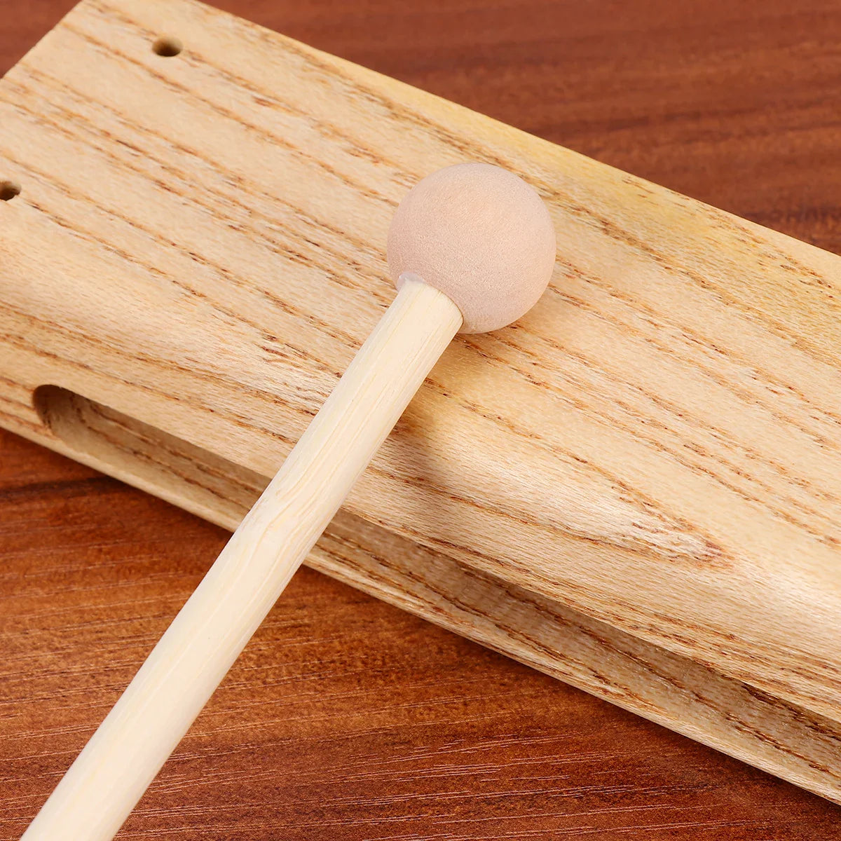 A light-colored madera dura outdoor percussion instrument wooden clapper with a soft foam head and matching block