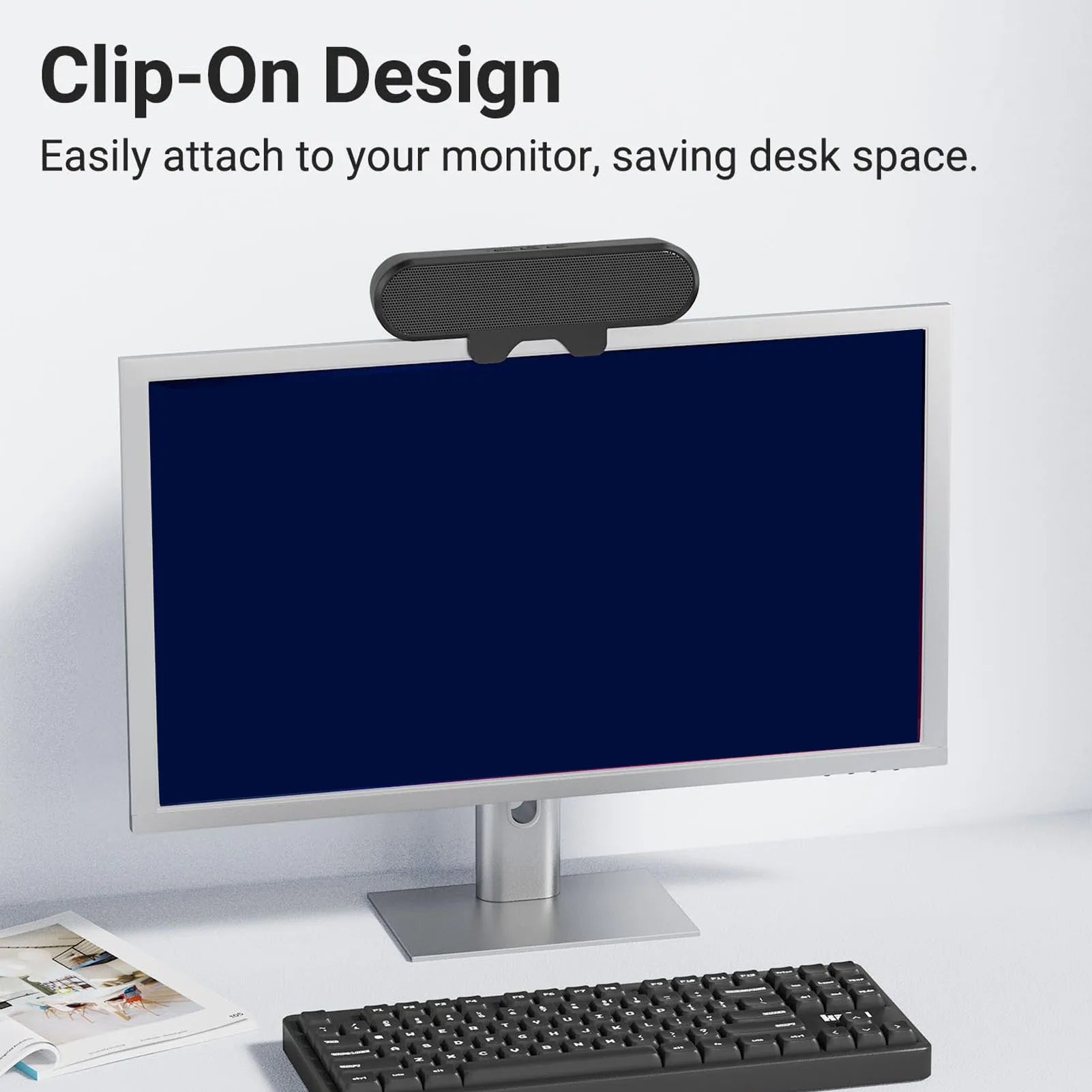 Black clip-on computer speaker with textured grille and sleek design featuring loud sound volume and high definition stereo
