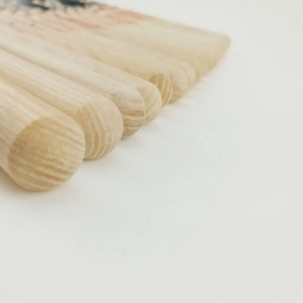 Light-colored wooden percussion musical instrument sticks with smooth rounded ends and visible wood grain for training