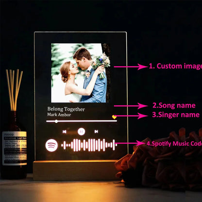 A sleek black personalised acrylic spotify music plaque with custom couple photo and wooden base led night light