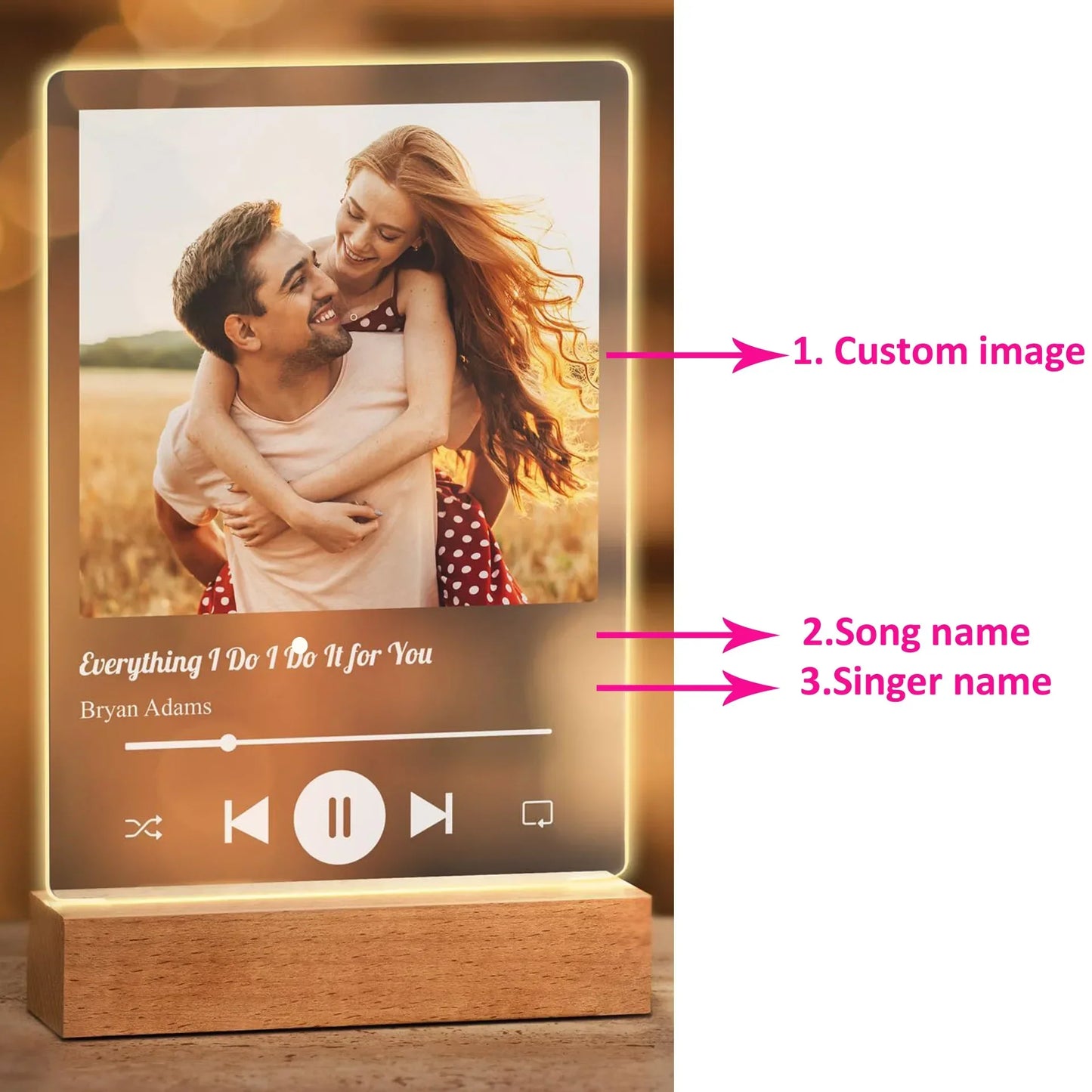 A warm-lit personalised acrylic spotify music plaque with wooden base displays custom couple image and engraved song title