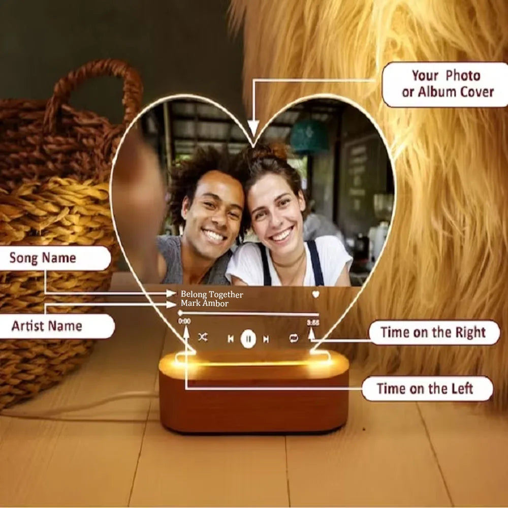 Heart-shaped personalised acrylic spotify music plaque with warm amber led glow and wooden base showing couple photo
