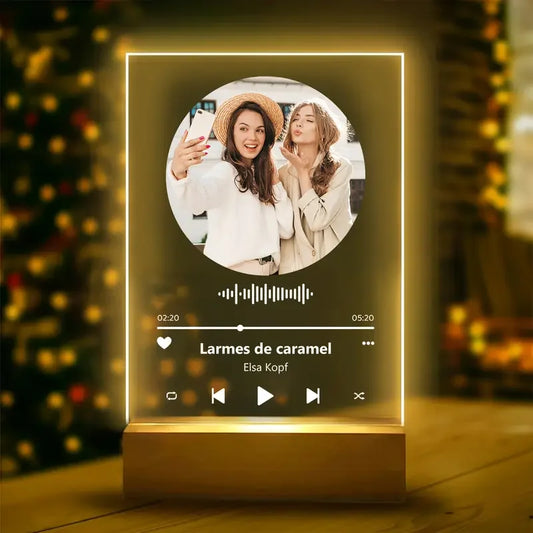 A glowing personalised acrylic spotify music plaque with led light and wooden base displaying a custom photo and song