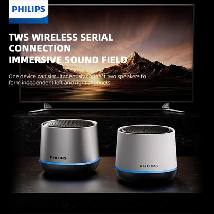 Two philips tas1009 tws wireless portable desktop speakers in silver and white with blue accent ring and rgb subwoofer