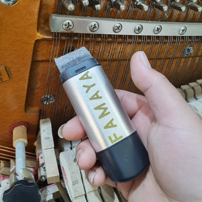 Silver and black famaya piano key cleaner with gray felt tip for piano string rust removal and rust removal tool use