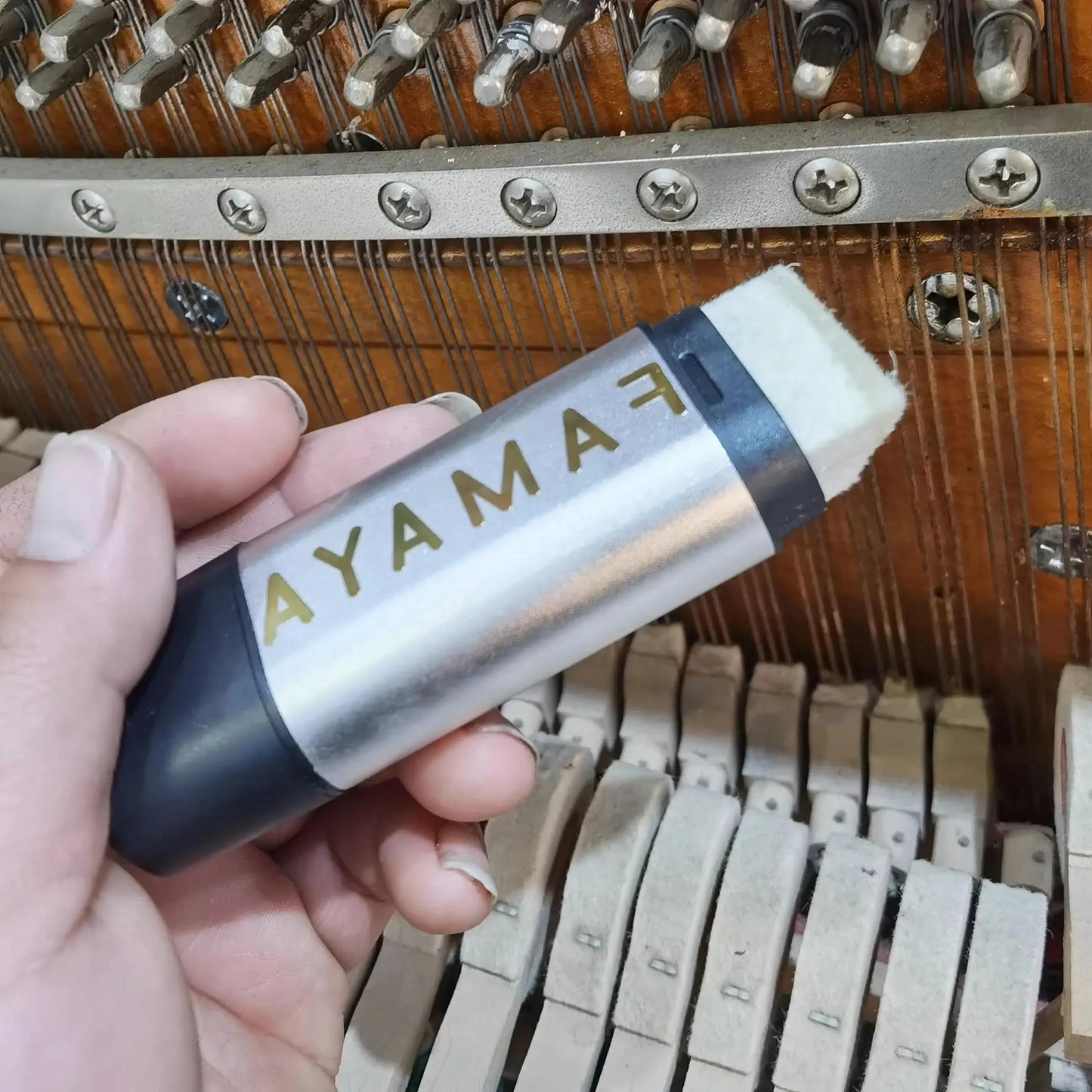 Silver and black fayama piano key cleaner with white eraser tip for piano string rust removal and rust removal tool use