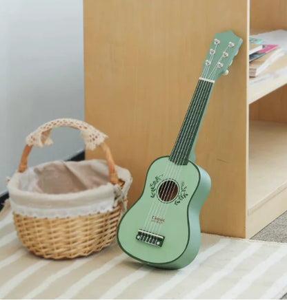 Mint green plastic ukulele with floral decals and black pickguard for boys to play mechanical music at beat music store
