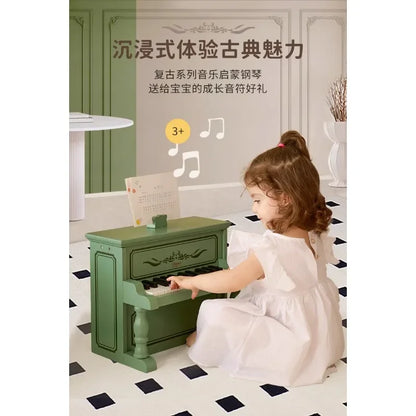Green wooden piano with ornate detailing and black-and-white keys for boys to play mechanical music gift from beat music store