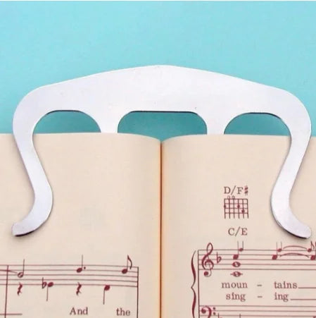 White plastic holder clip music bookmark with three curved slots for pianos stands song page holding speech draft cooking