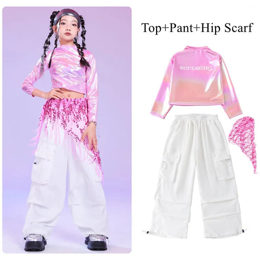 Pink hip hop long sleeve laser crop top with supergirl print paired with white pant and sequin hip scarf for kids stage wear