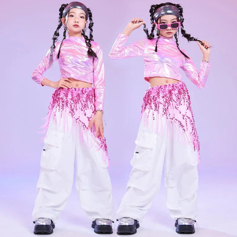 Shiny pink hip hop long sleeve laser crop top with high neckline paired with white pants and sequin hip scarf
