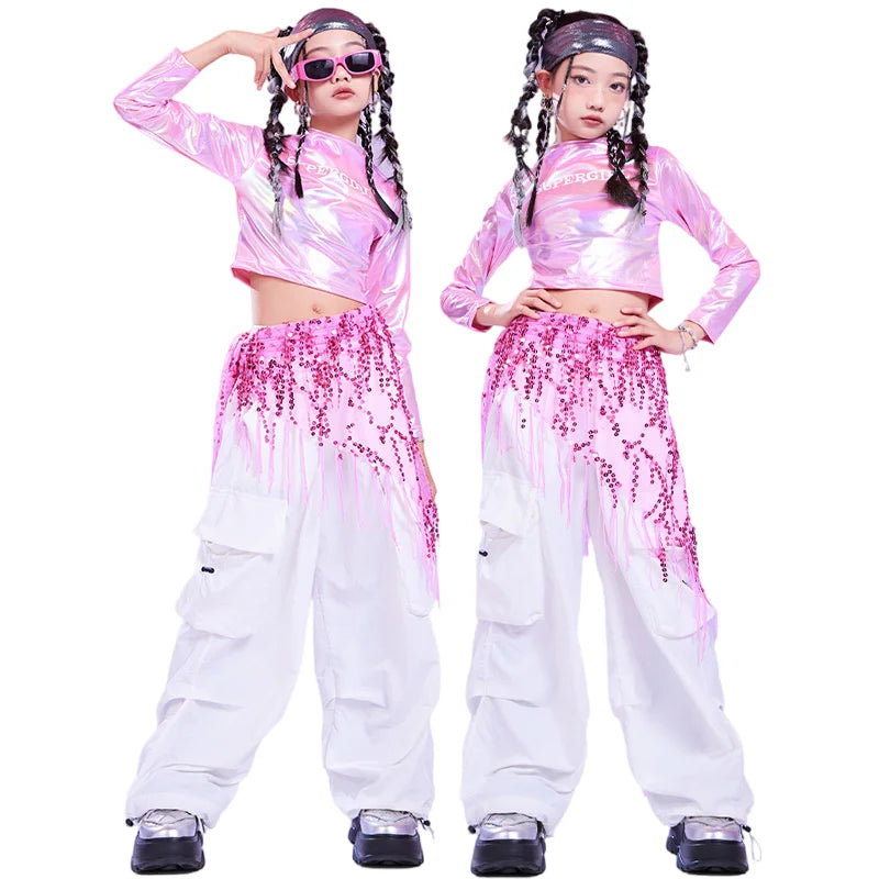 Pink hip hop long sleeve laser crop top with holographic finish paired with white cargo pants and sequin hip scarf