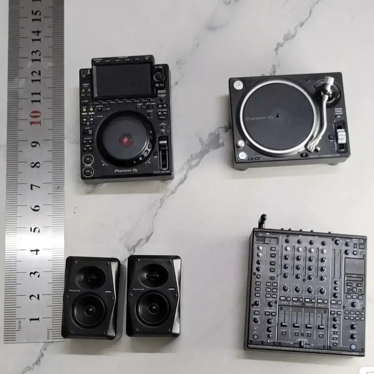 Black miniature pioneer dj controller set featuring mixer player keychain and two speakers in detailed model form