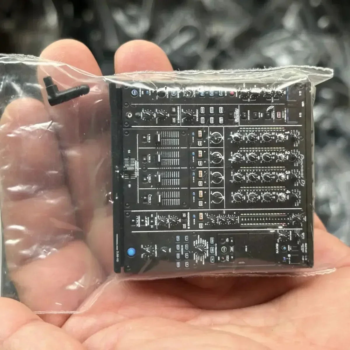 Black pioneer dj controller miniature model mixer with detailed knobs sliders in a player keychain design
