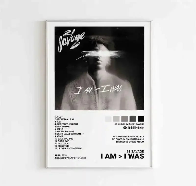 White-framed canvas wall art featuring a black-and-white 21 savage i am greater than i was album cover with tracklist and release details