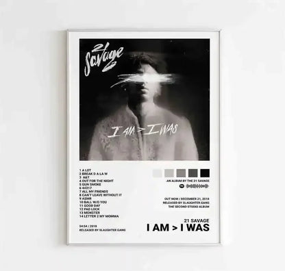 White-framed canvas wall art featuring a black-and-white 21 savage i am greater than i was album cover with tracklist and release details