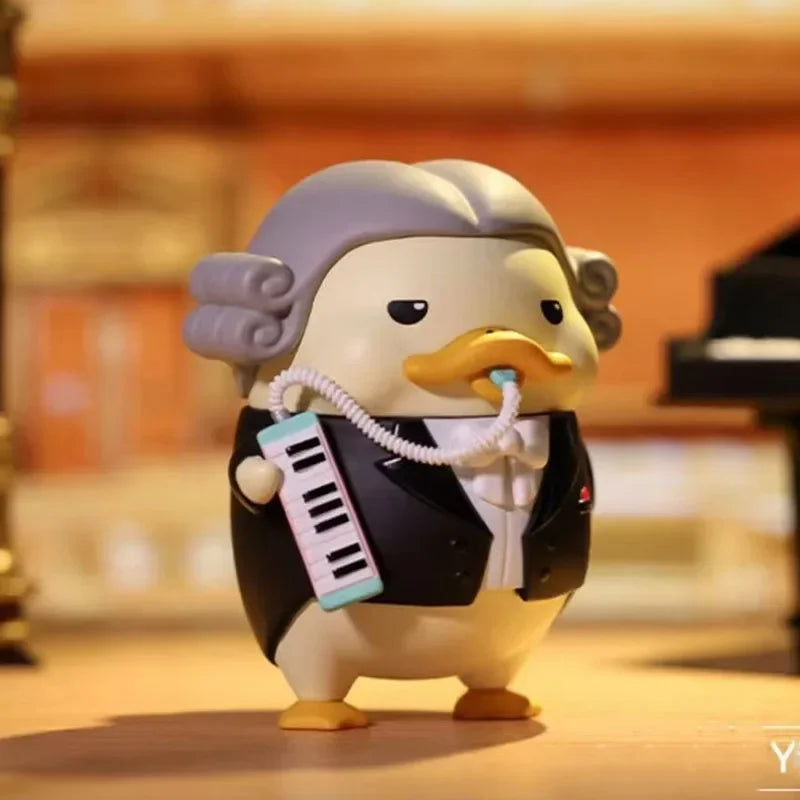 A cream-colored pop mart duckoo music festival figurine dressed in tuxedo holding a miniature keyboard from mystery box toys collection