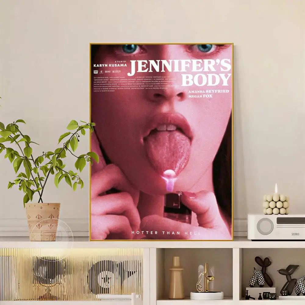 A framed modern graphic pop movie jennifer body poster with a close-up woman holding lighter to tongue in pinkish tones