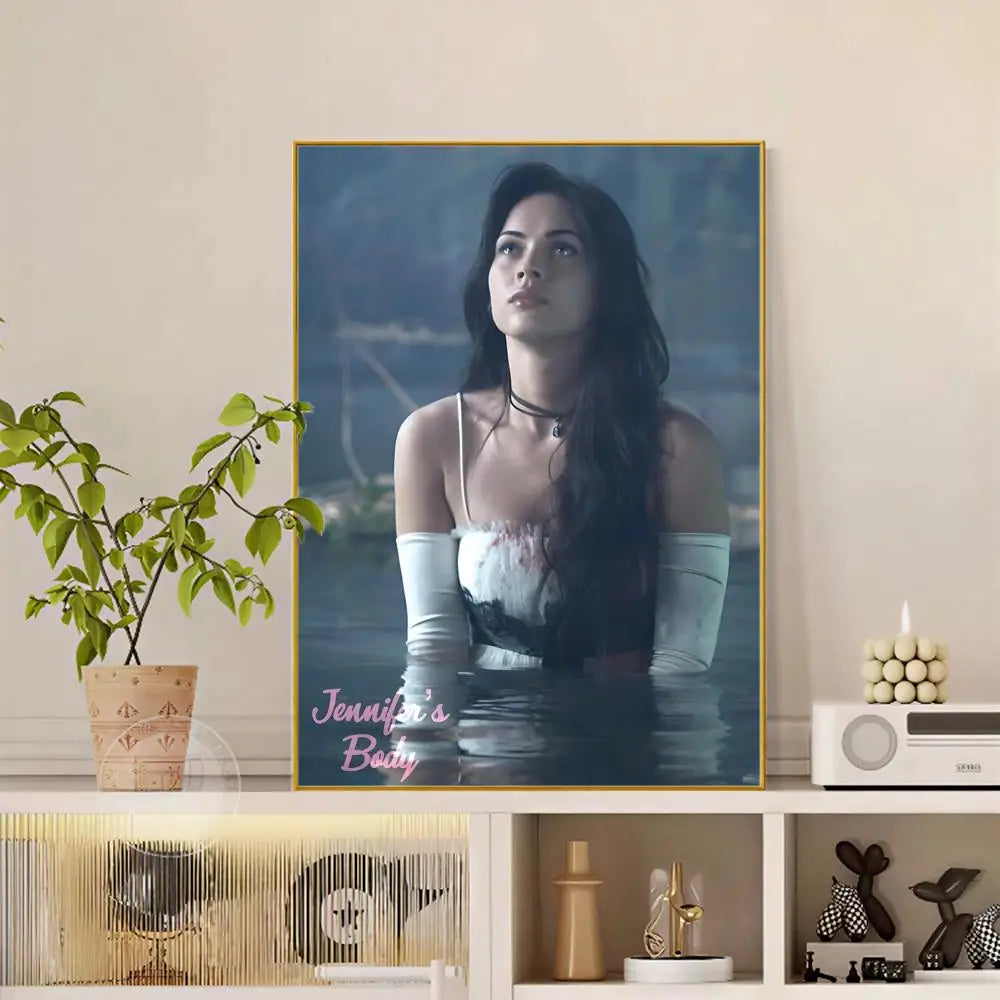 A framed pop movie Jennifer body poster with modern graphic featuring a woman in white gloves against blue water backdrop