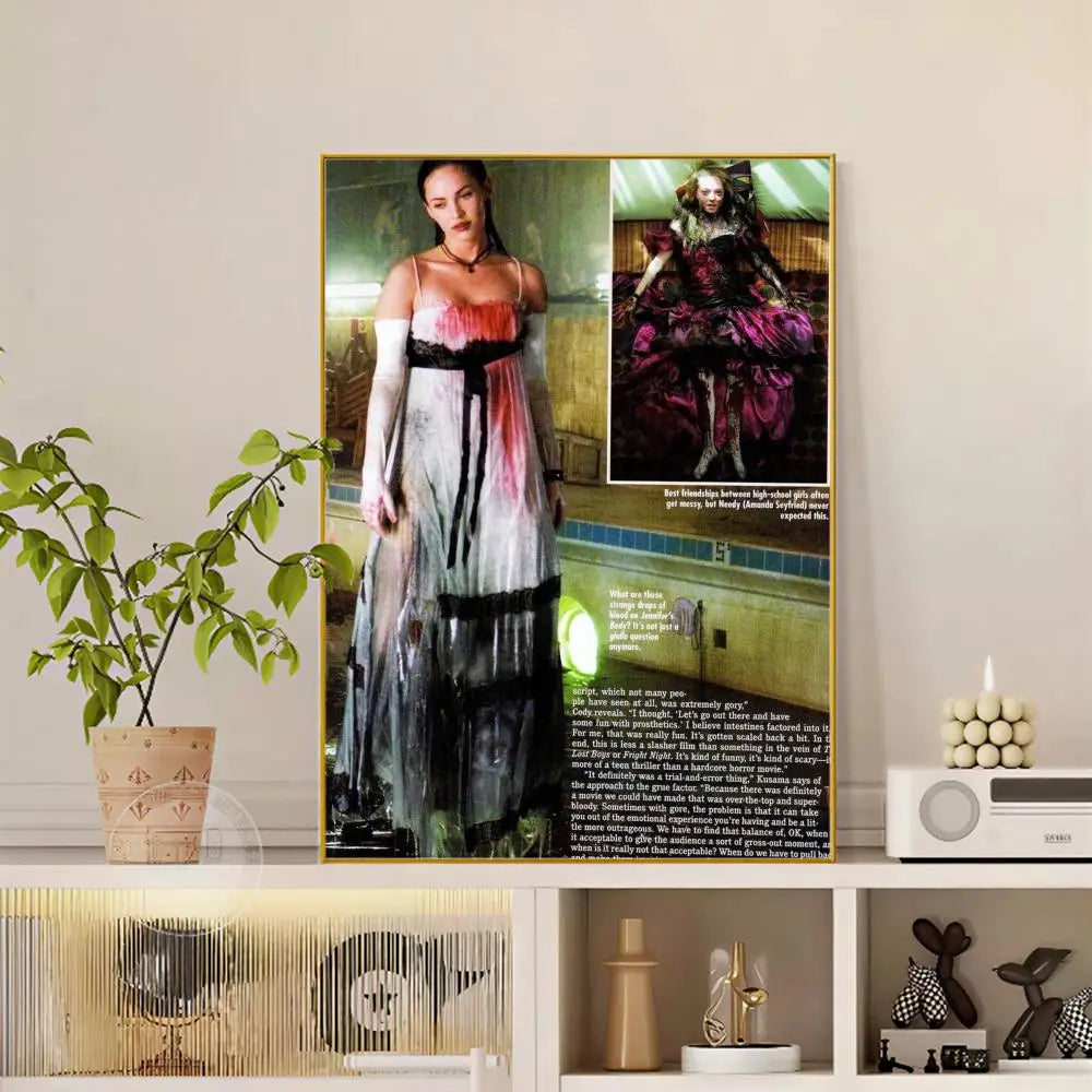 A framed pop movie Jennifer Body poster featuring a woman in a distressed white black and red gown with modern graphic design