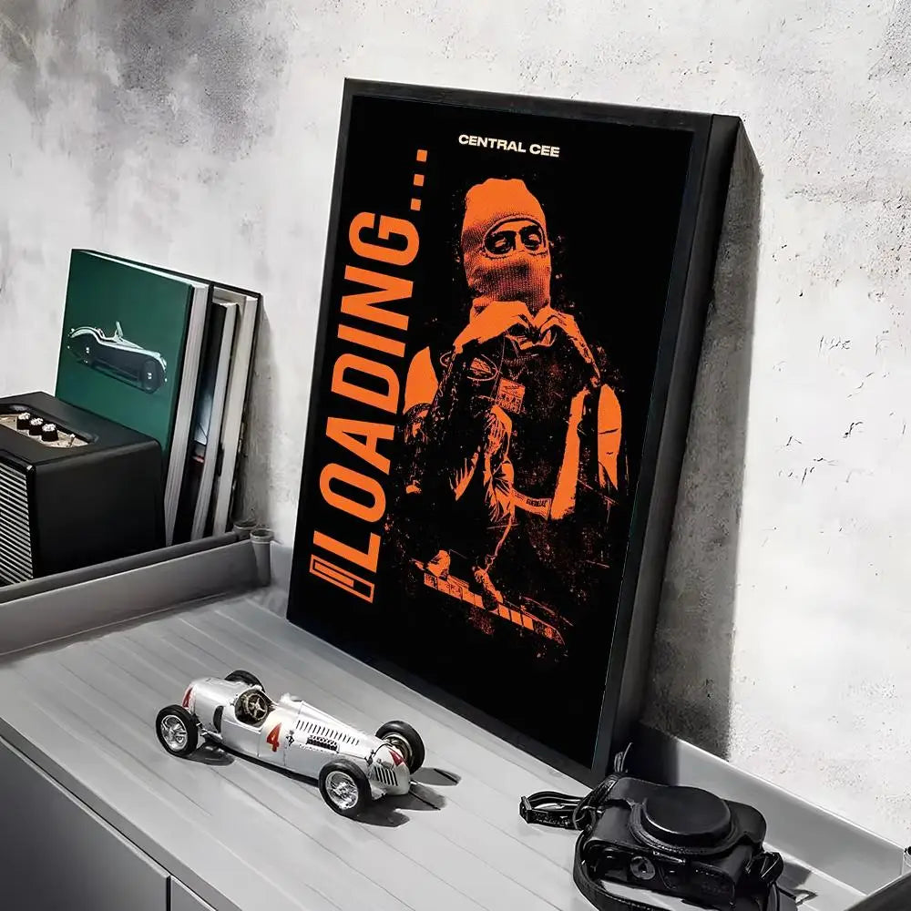 Black-framed hd linen canvas poster featuring bold orange loading text and masked pop rapper illustration with lighting effects for home decor and working days