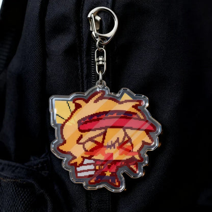 A vibrant pixel-art style acrylic cartoon chibi keychain with spiky orange hair and red eyes for game lovers