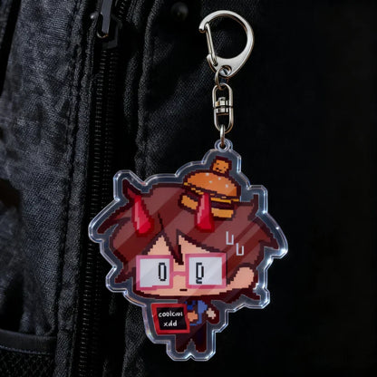 Clear acrylic cartoon chibi keychain with pixel art brown hair character, red horns, glasses, and hamburger top for bag charms