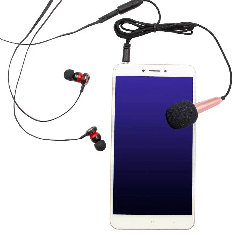 Pink and black foam-covered stereo studio mic with metallic finish and coiled cable for handheld audio microphone use