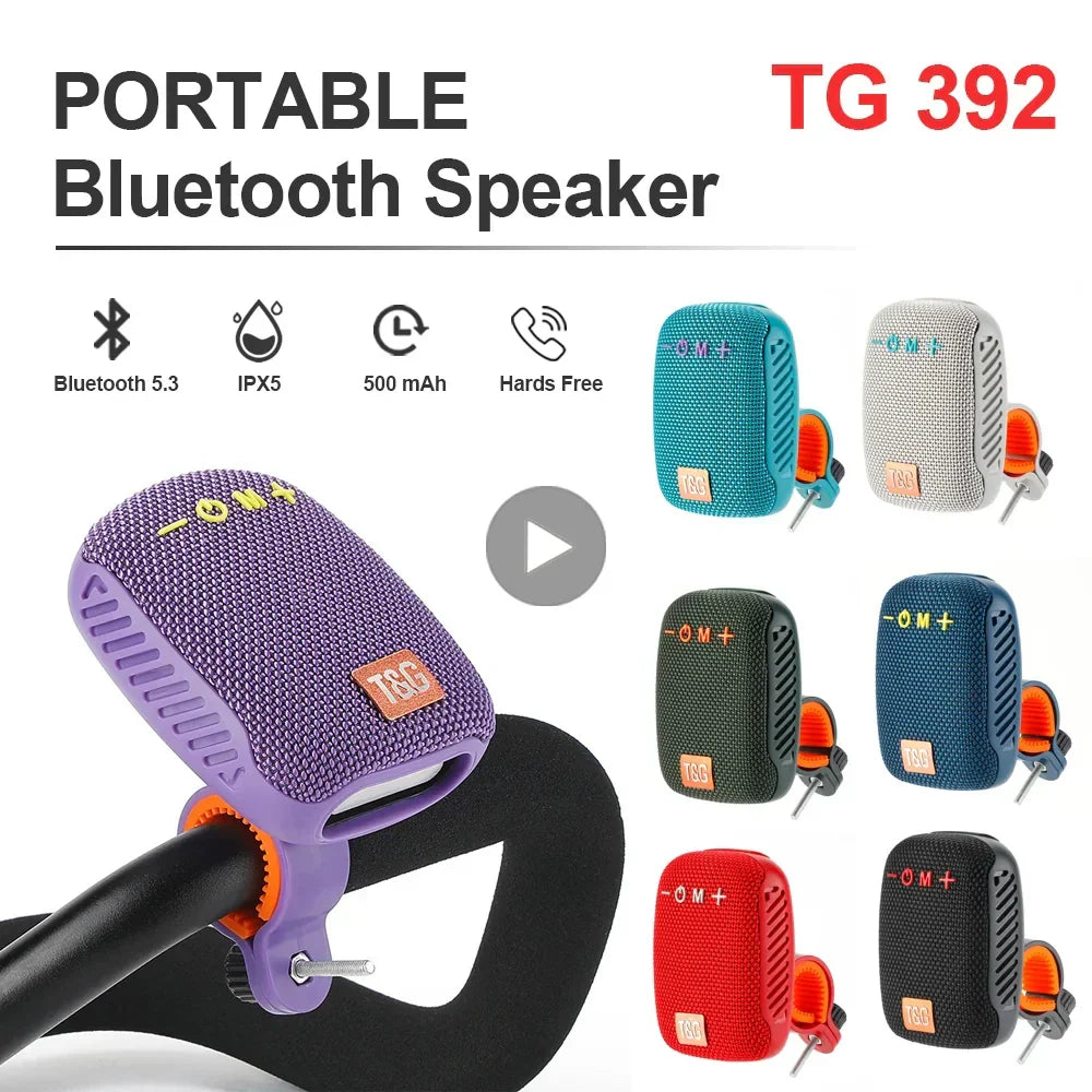Purple woven-textured bluetooth speaker wireless with orange clip and tg 392 branding featuring radio fm subwoofer woofer mini waterproof design