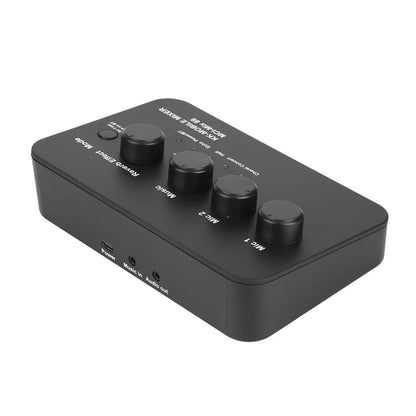 Black rectangular portable karaoke microphone mixer with four rotary knobs and labeled power music in and audio out ports