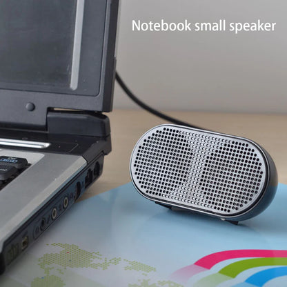 Silver oval-shaped mini speaker with perforated grille and black trim offers good performance for laptop soundbox use