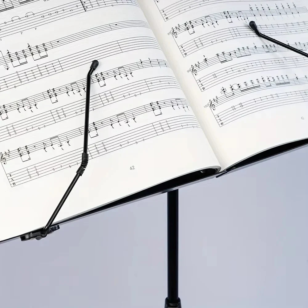 Black folding metal music stand holding open sheet music portable lightweight adjustable stable music with carrying bag
