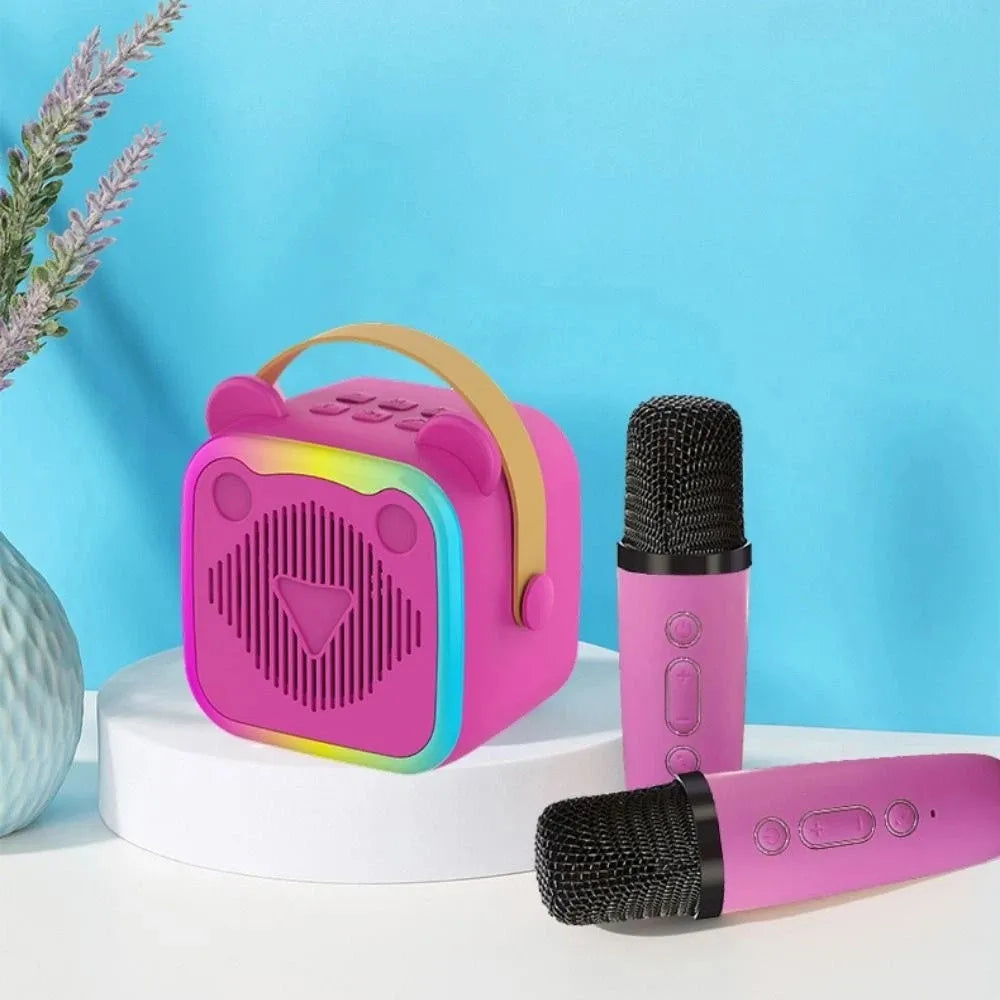 Pink bear-shaped portable mini karaoke speaker wireless with rainbow trim tan handle and wireless microphones rgb lights