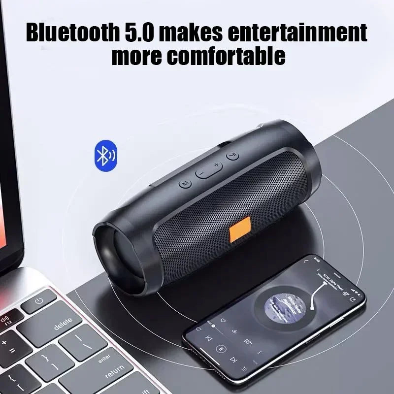 Black cylindrical portable subwoofer bluetooth speaker with orange accent mesh grille for outdoor stereo surround use
