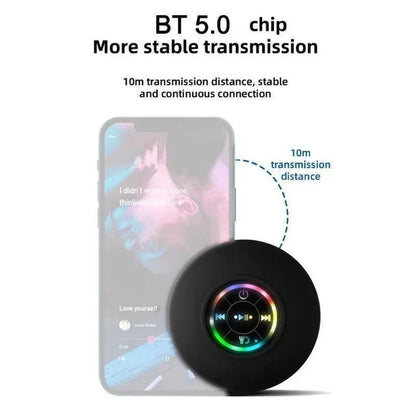Black circular bluetooth speaker with suction cup waterproof design and colorful illuminated control interface with led ring