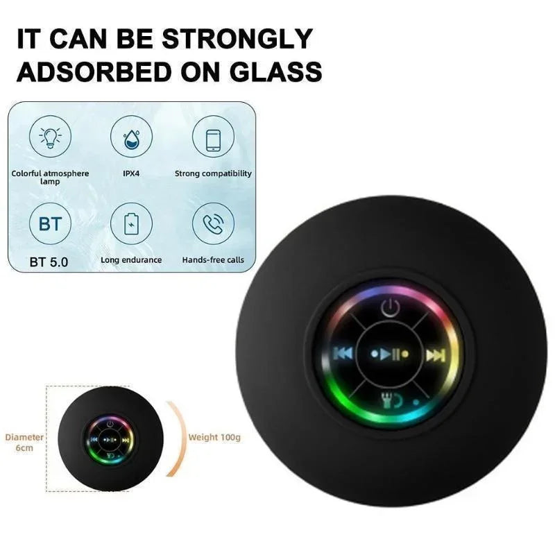 Black circular bluetooth speaker with suction cup and colorful led lighting around control buttons for portable use
