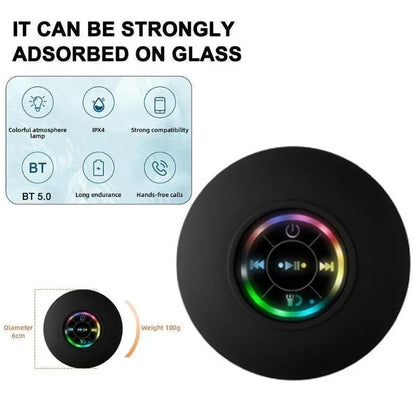 Black circular bluetooth speaker with suction cup and colorful led lighting around control buttons for portable use