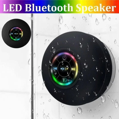 Black circular bluetooth speaker with suction cup features rainbow buttons and a sleek waterproof luminous design