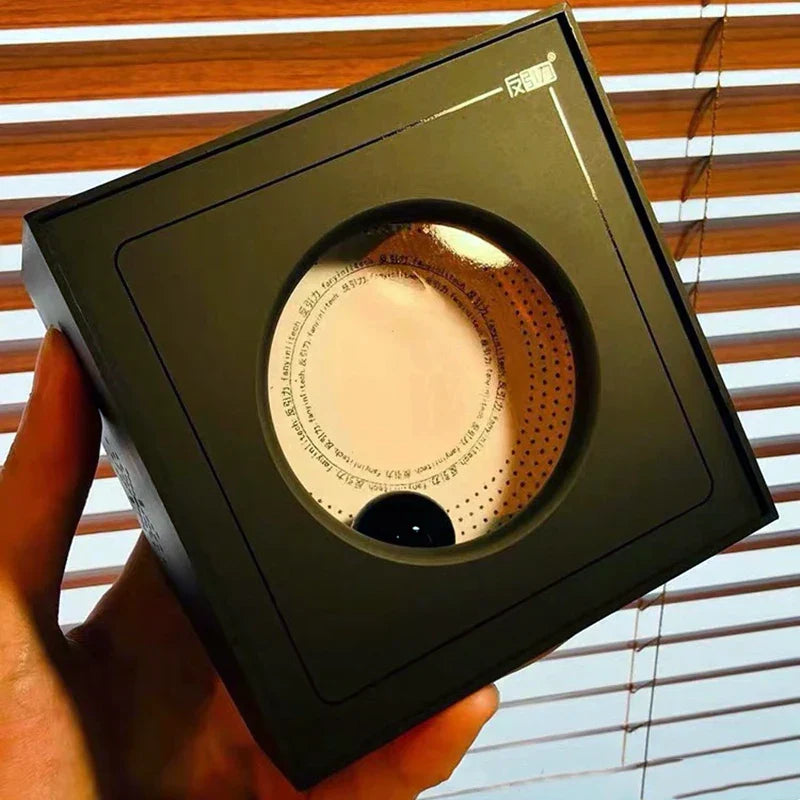 Black rectangular portable visual music box with circular cutout showing white and gold venom sensor ferrofluid interior design