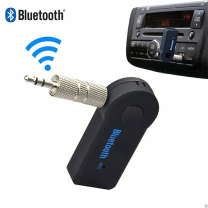 Black portable wireless bluetooth-compatible music receiver with silver 3.5mm male audio jack plugged into aux port