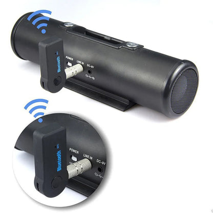 Black cylindrical matte finish portable wireless bluetooth music receiver with integrated 3.5mm male audio adapter