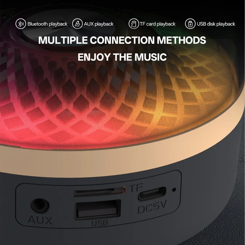 A sleek portable wireless theater speaker subwoofer with textured glowing acoustic breathing lamp and matte gray base