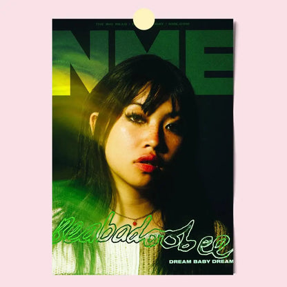 A modern graphic poster featuring a woman with dark hair and red lipstick against green and yellow lettering for home decor