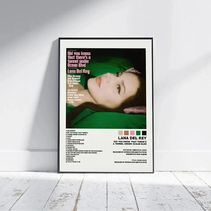 A framed poster featuring lana del rey with green and pink text of her did you know that theres a tunnel under ocean blvd album artwork for home decor