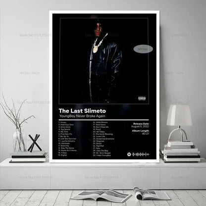 Black and white poster print featuring youngboy never broke again in glossy black leather jacket with gold chains promoting last slimeto album